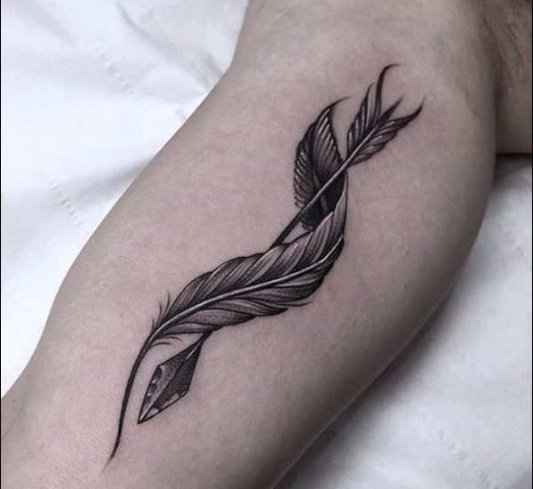 feather and arrow tattoo on forearm