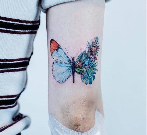 watercolor butterfly tattoo on biceps