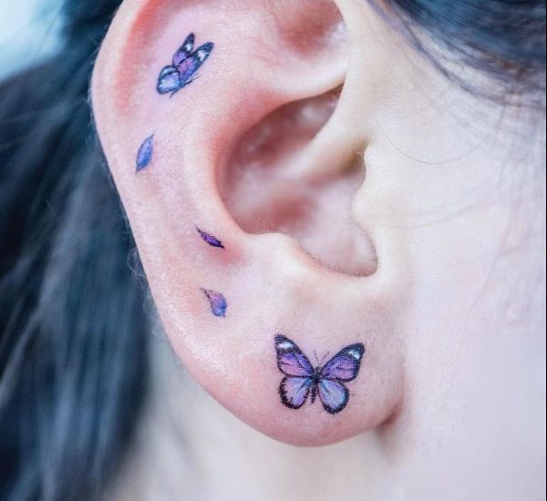 small butterfly tattoo on ear