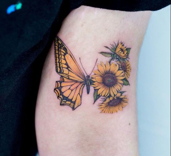 sunflower with butterfly tattoo on biceps