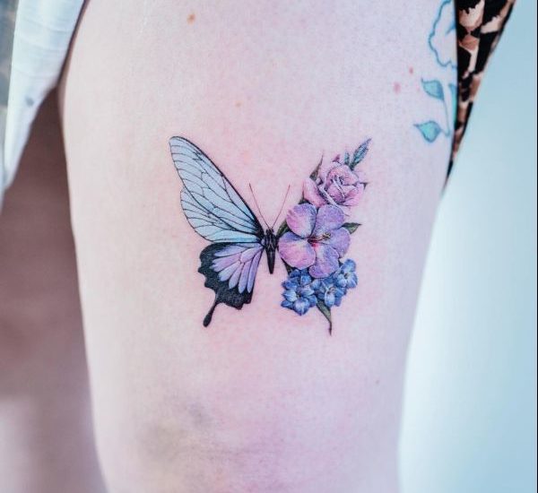 butterfly with flowers on thigh tattoos