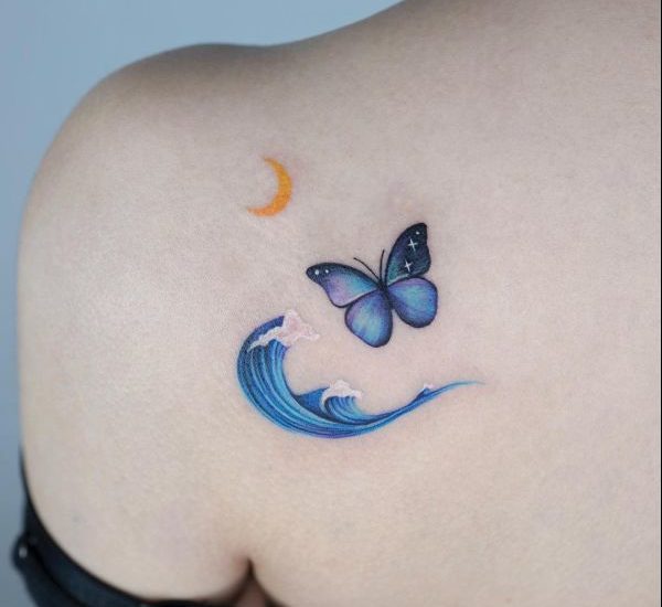 moon ocean wave and butterfly tattoo on back