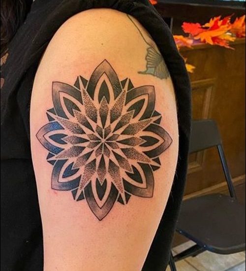 Geometric mandala tattoo design on shoulder