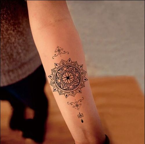Small cute mandala tattoo on the inner forearm.