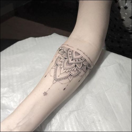 Quarter lotus mandala tattoo on inner forearm