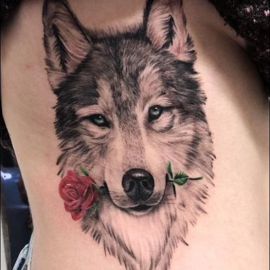 Wolf face and red rose tattoos