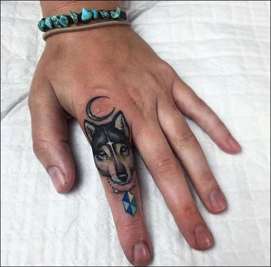 Moon and small wolf face tattoo designs on finger