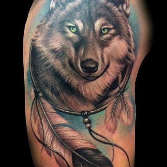 dreamcatcher, feather and wolf tattoos on shoulder
