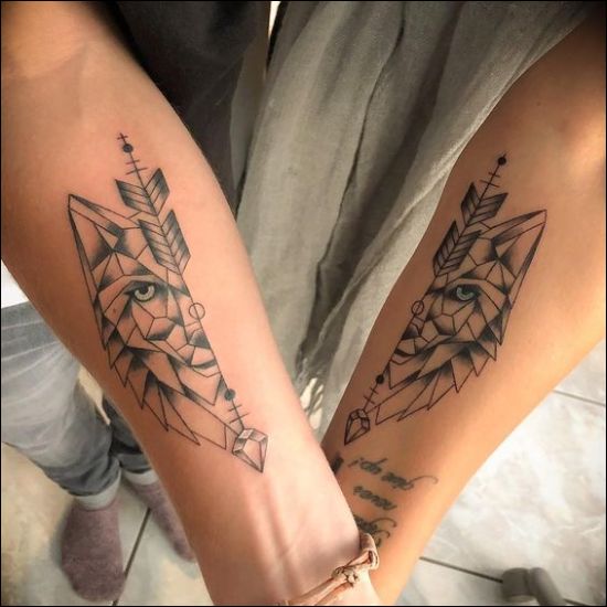 geometric wolf face tattoo design with an arrow