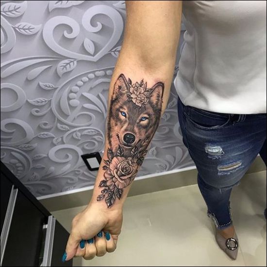 blue eyes wolf tattoo designs with rose flowers on the inner forearm