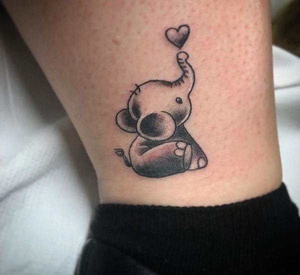 small elephant with heart ankle tattoo