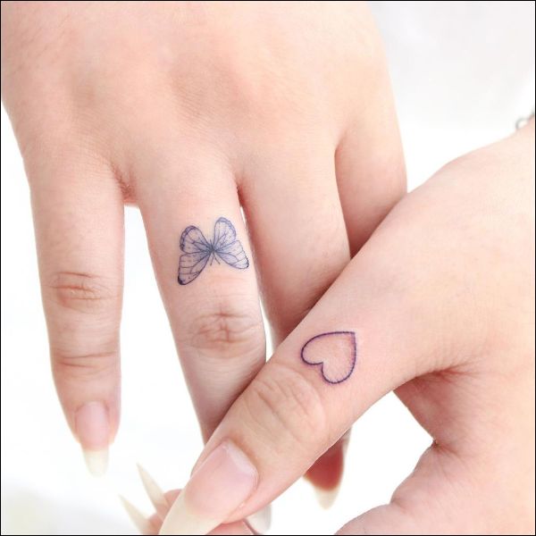 Butterfly and heart tattoo finger