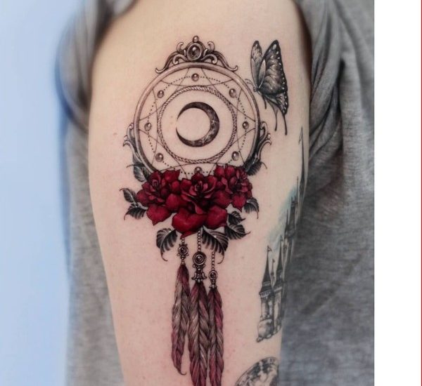 rose and dreamcatcher tattoo with butterfly on shoulder