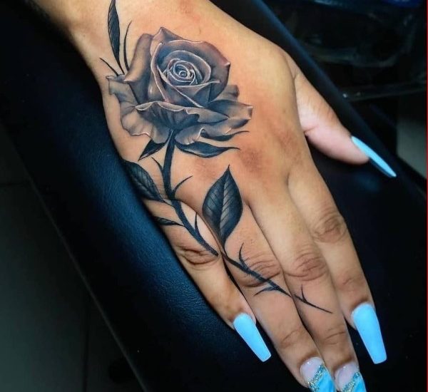 Black rose tattoo design on hand