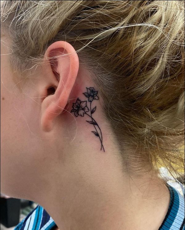 rose tattoo behind the ear