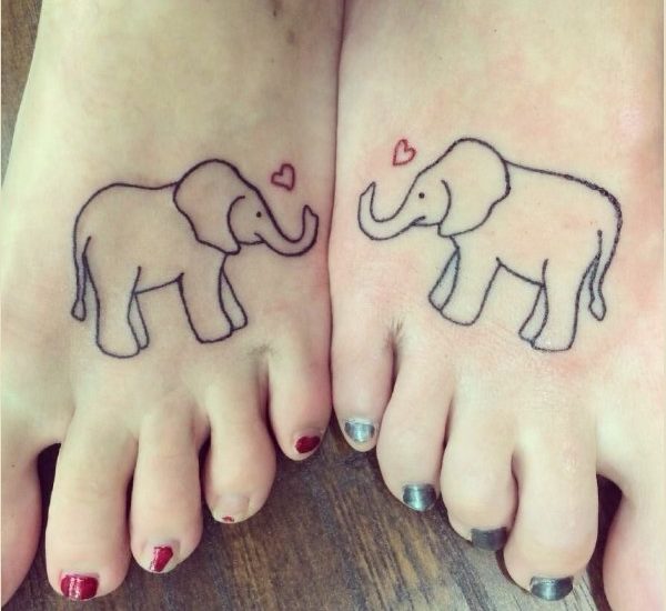Inner foot tattoo of a boa constrictor with an elephant