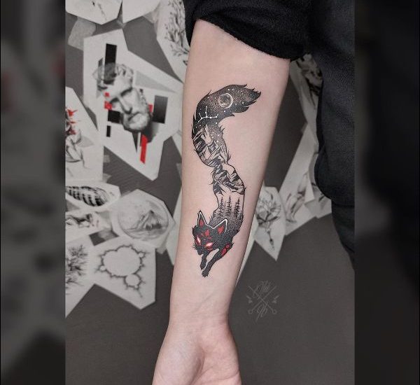 Black and red fox tattoo design on forearm