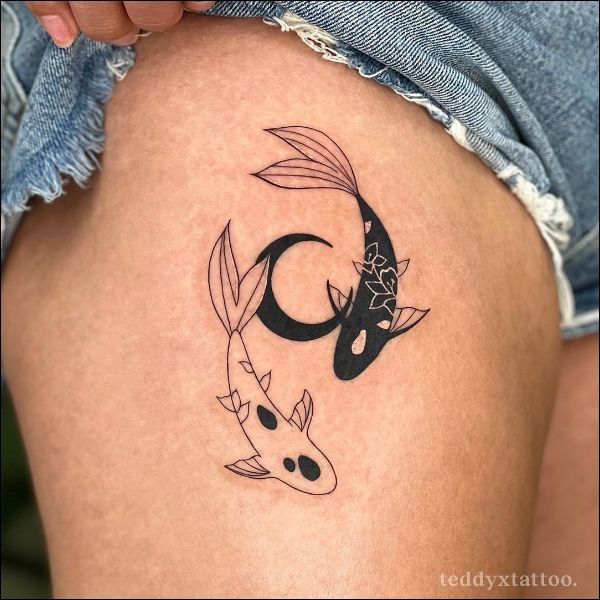 Yin yang fish tattoo on the inner forearm
