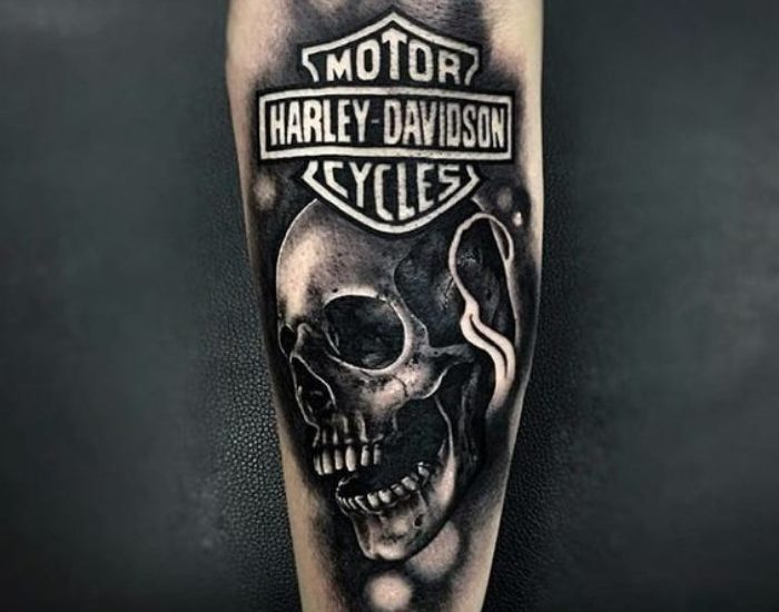 Harley Davidson motorcycle with skull tattoo on forearm