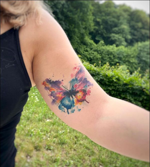Butterfly watercolor tattoo design on biceps