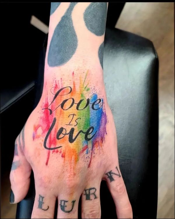Love is love watercolor tattoo on hand