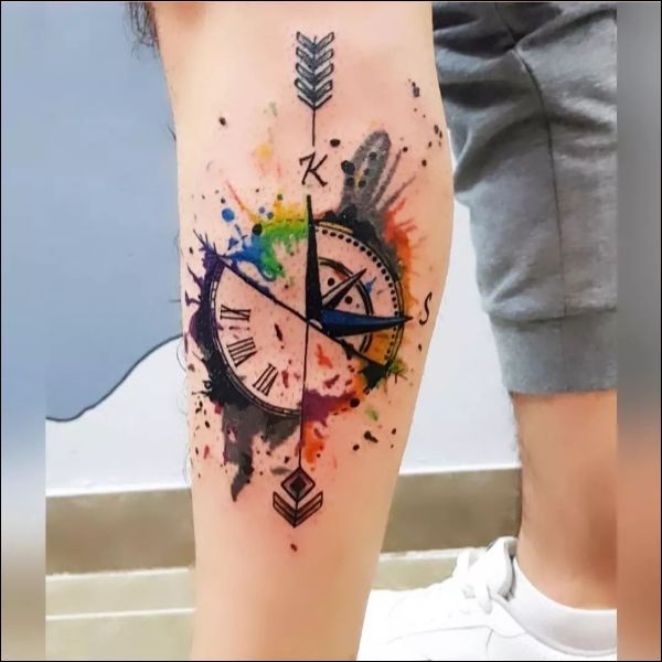 Compass and arrow tattoo design on leg