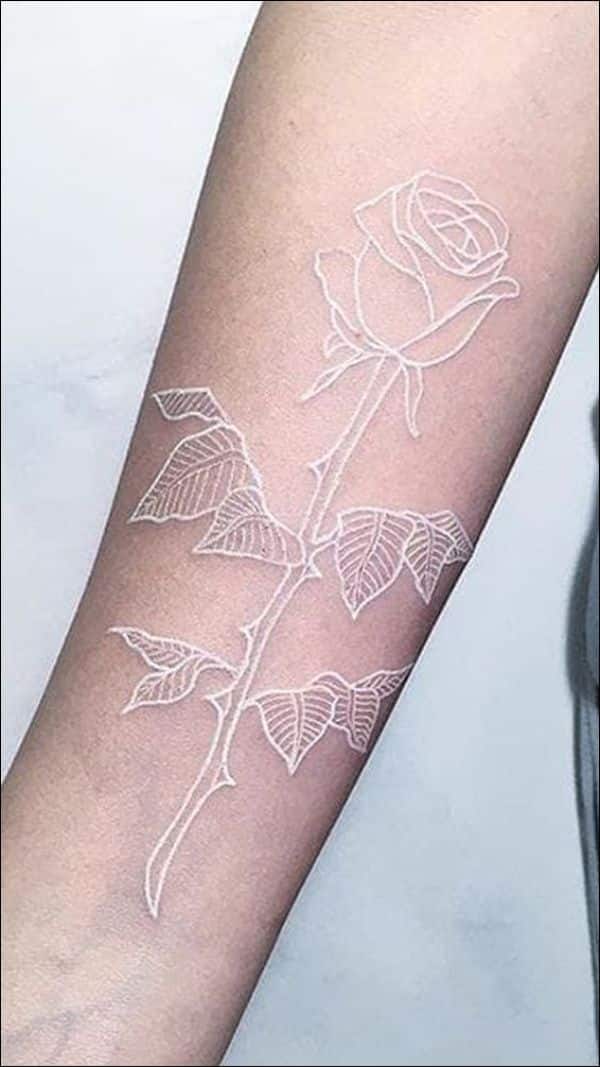 healed white ink tattoo on dark skin